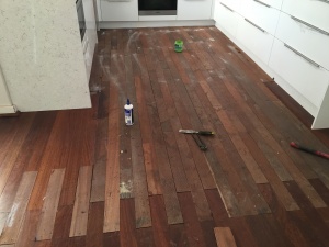 Replacing damaged timber floorboards in the kitchen.